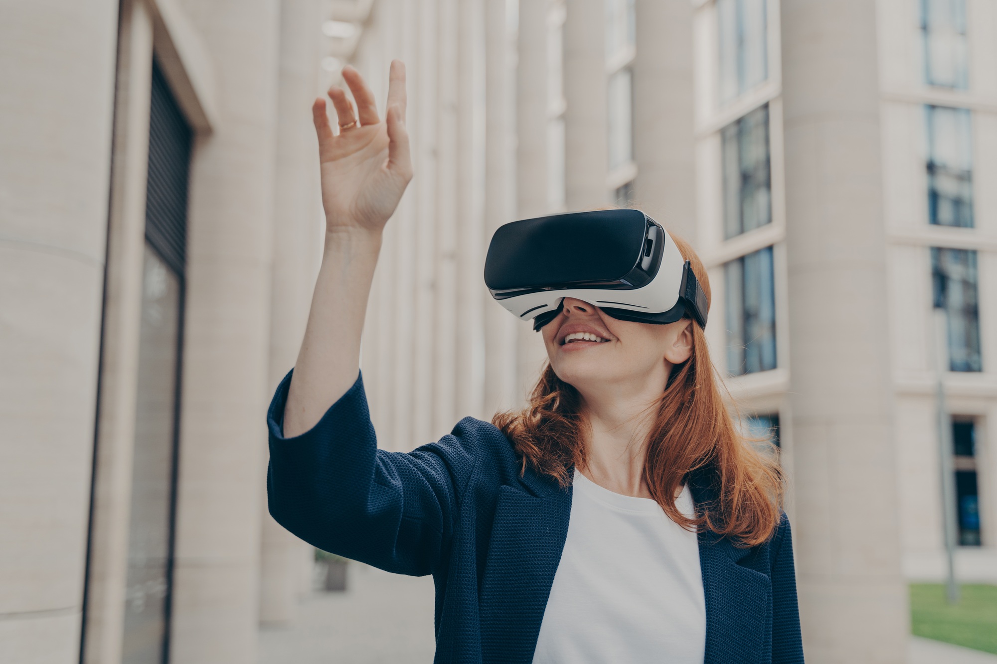 Redhead businesswoman managing business project through virtual reality platform